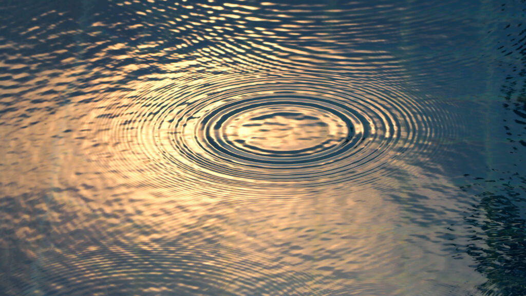 Rain drops on the swimming pool blue water surface that have ripple wave effect on liquid texture and top view angle.